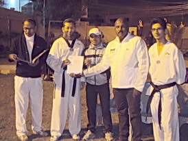 Taekwondo Master Ashfaq giving Taekwondo championship participation certificate to Suqrat Farooqi Coach & Cheif Instructor Prince Taekwondo Academy